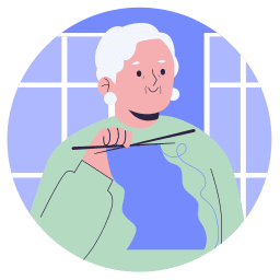 un senior qui tricote dans son logement social